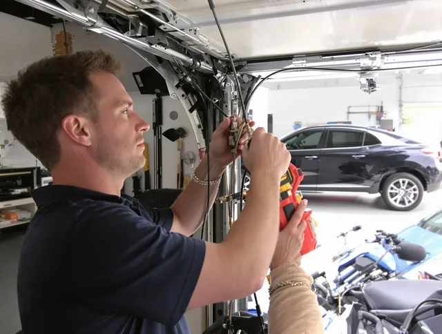 Cuyahoga Falls Garage Door Repair safety certified technician performing cable replacement in Cuyahoga Falls